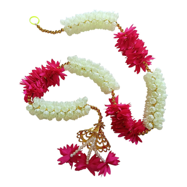 Pink and white floral Diwali door hanging with gold beads, a decorative cap and dangling pink flower tassels.