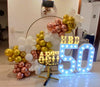 balloon ring decoration with marquee number 50 milestone birthday backdrop gold white balloons, in an event decoration layout for a themed celebration and party photographs.
