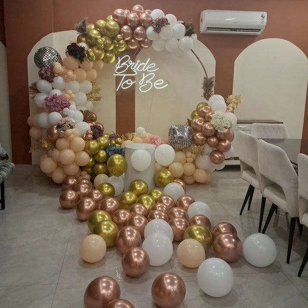 Bride to Be neon sign within a gold and rose gold balloon ring, done by Funzoop Party Store