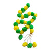Green and yellow pom-pom Diwali door hanging with a gold decorative cap, white sprigs and three dangling floral tassels.
