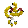 Yellow pom-pom Diwali door hanging with red flower accents, green leaves, a gold decorative cap and dangling floral tassels.