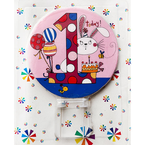 Pink round number 1 first birthday cake candle in packaging