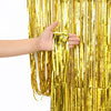 Gold silver purple and green metallic party curtain decoration for creating a reflective background behind a cake table or party photo area.