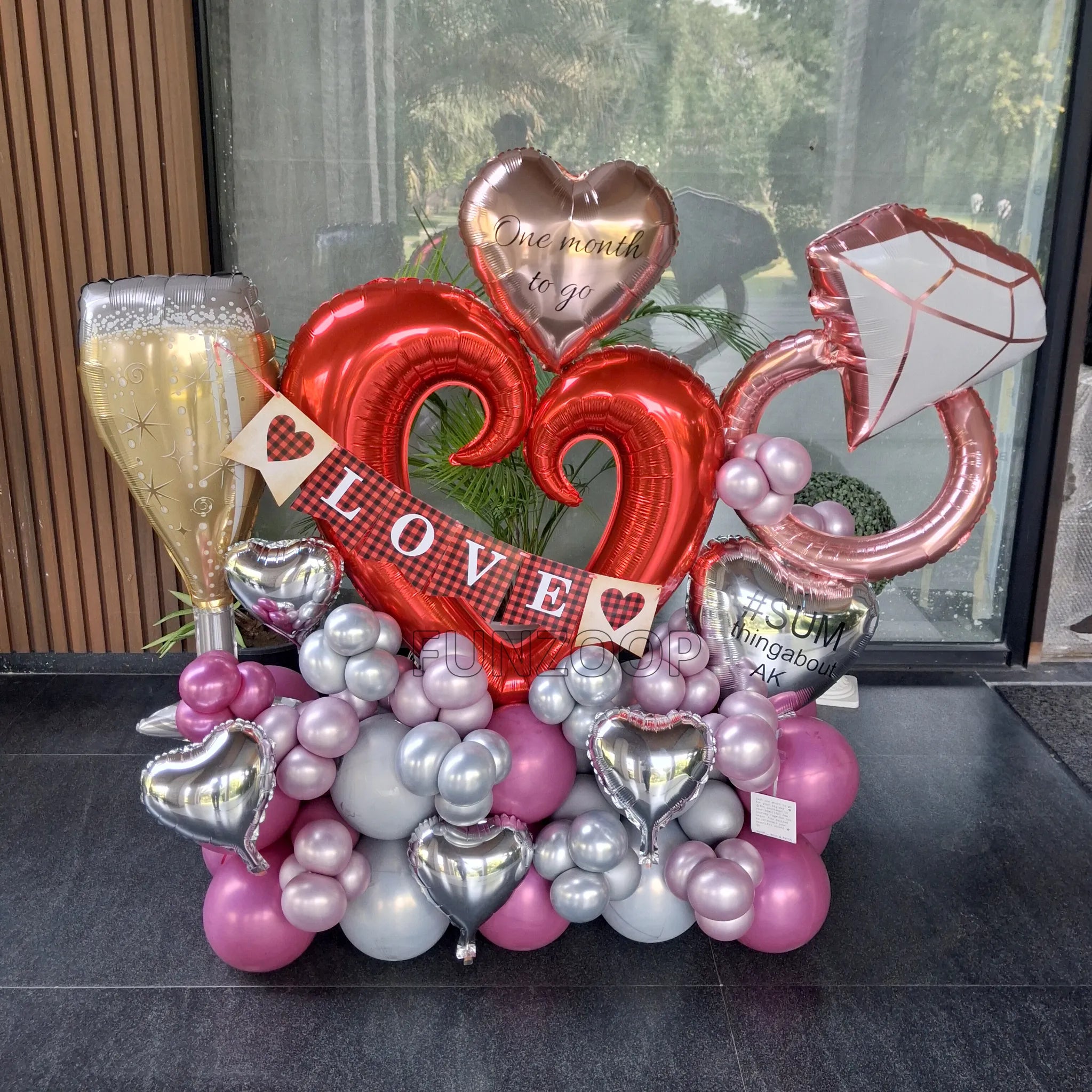 Personalised bachelorette balloon arrangement featuring champagne glass, diamond ring, heart balloons and LOVE banner, done by Funzoop Party Store