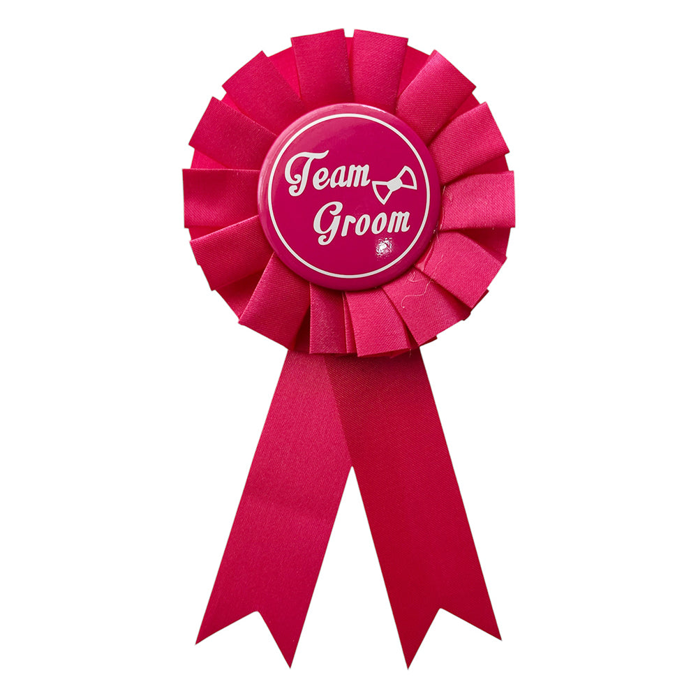 Pink Team Groom rosette badge with decorative ribbon tails from Funzoop The Party Shop