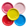 Several seven inch paper party plates shown together in pink, pale pink, yellow, red and blue for colourful dessert settings.