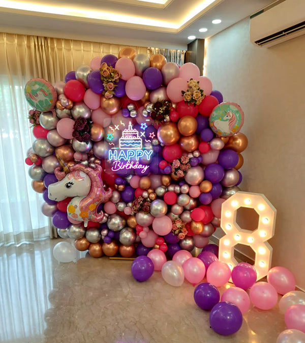 Unicorn Theme Happy Birthday Balloons & Flowers Wall with LED Number Milestone, in an event decoration layout for a themed celebration and party photographs.