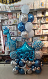 Blue and silver baby boy balloon centrepiece with giraffe foil and helium bunch.