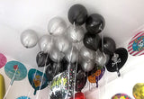 Black and silver metallic helium balloons arranged across a ceiling, done by Funzoop Party Store