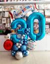 Blue birthday balloon centerpiece with number balloons and Happy Birthday banner by Funzoop, Gurgaon