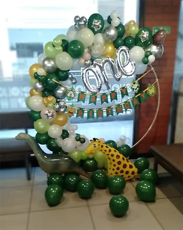 First Birthday Dinosaur Theme Balloons Arch Decoration, in an event decoration layout for a themed celebration and party photographs.
