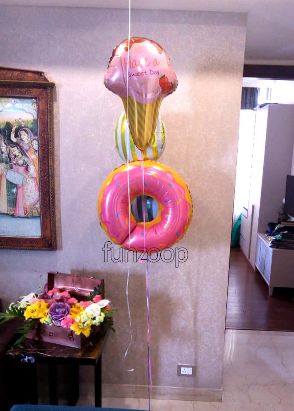 Donut Ice Cream Candy Foil Balloons Bouquet shown in a styling reference for food-themed birthdays and playful celebrations, with extra decorations separate from this listing.