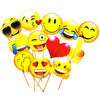 Assorted yellow emoji photo props with expressive faces, red hearts and hand gestures grouped together on wooden sticks.