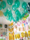 Green and white helium balloons styled as a ceiling display, done by Funzoop Party Store