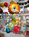 Happy Birthday Lion Jungle Theme Bouquet shown in a styling reference for animal-themed birthdays and safari celebrations, with extra decorations separate from this listing.