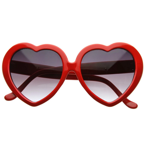 Heart-shaped novelty party goggles presented as a wearable photo prop, providing a simple shaped accessory for birthday portraits and celebration photographs.