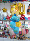 Welcome Baby Boy Cap Giraffe Balloons Bouquet shown in a styling reference for animal-themed birthdays and safari celebrations, with extra decorations separate from this listing.