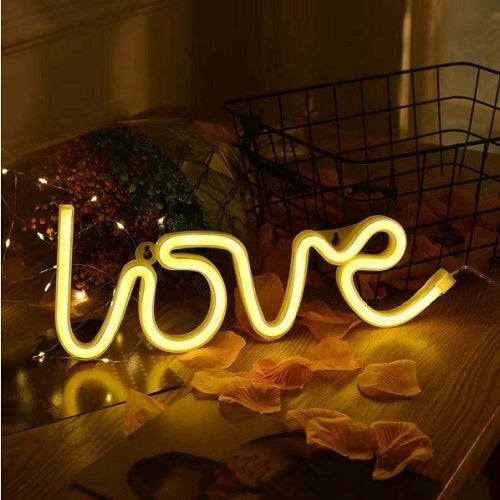LOVE Decor Neon Sign, as a decorative lighting accent for a themed party table or display area.