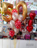 Milestone number foil balloons with red hearts, assorted latex balloons and matching ribbons