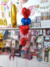 Red, blue and pink heart-shaped foil balloons displayed as a helium bouquet delivered by Funzoop Party Store