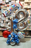 Silver birthday balloon centerpiece with number balloons and Happy Birthday banner by Funzoop, Gurgaon
