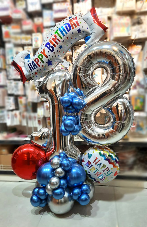 Silver birthday balloon centerpiece with number balloons and Happy Birthday banner by Funzoop, Gurgaon
