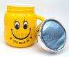 Smiley Yellow "You Make Me" Mug with open lid, with the ceramic body and matching lid forming a coordinated novelty drinkware design.