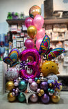Pink butterfly milestone balloon centrepiece with an accompanying helium balloon bouquet sold by Funzoop Birthday Shop.