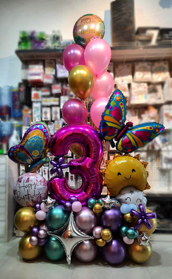Pink butterfly milestone balloon centrepiece with an accompanying helium balloon bouquet sold by Funzoop Birthday Shop.