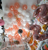 White and rose gold metallic helium balloons arranged across a ceiling, done by Funzoop Party Store